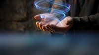 Hand holding glowing holographic tablet with blue light effect, representing future technology, digital innovation, and virtual interface for business and communication concepts.
