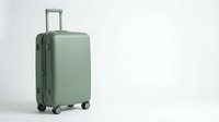 Sage green hardshell spinner suitcase on white background, isolated travel luggage for vacation, business trip, or airport journey.