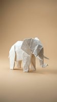 White origami elephant paper sculpture on neutral beige background showcasing traditional Japanese folding art and minimalist design aesthetic.