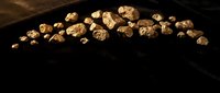 Fresh walnuts scattered on dark wooden surface creating rustic food photography composition for culinary and healthy eating concepts.