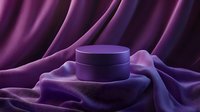 Purple cosmetic jar on luxurious silk fabric with elegant folds and dramatic lighting, creating sophisticated mood for beauty product photography and advertising.