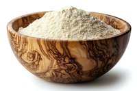 White flour in decorative wooden bowl with natural grain pattern, photographed on white background for cooking, baking and food preparation concepts.