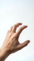 Male hand reaching upward in grasping gesture isolated on white background for design and commercial use.
