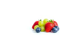 Fresh mixed berries and grapes isolated on white background for healthy eating concepts, smoothie recipes, and organic food marketing materials.