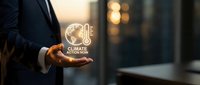 Climate action now icon glowing in businessman's hand against blurred urban background, representing environmental sustainability commitment and corporate responsibility.