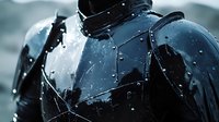 Dramatic close-up of wet black motorcycle gear with water droplets and rain splashing on reflective surface in moody lighting conditions during stormy weather.