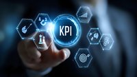 Businessman touching KPI digital interface with performance metrics icons in hexagonal shapes on dark blue background for business analytics.