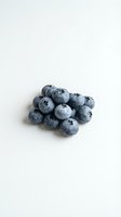 Fresh blueberries cluster on clean white background for healthy eating and nutrition concepts in food photography and culinary design projects.