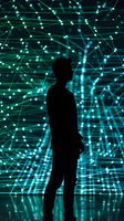 Silhouette of person against glowing turquoise network visualization display showing interconnected nodes and lines, representing digital transformation.