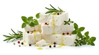 Fresh white cheese cubes with herbs, olive oil and peppercorns on white background. Dairy product for cooking and gourmet cuisine isolated.