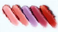 Colorful lipstick smudges showing different shades from coral pink to deep red, smeared makeup texture swatches on white background for beauty and cosmetics design.