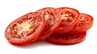 Fresh sliced red tomatoes arranged in overlapping circles showing juicy interior with seeds and pulp, ideal for cooking, salads, and food photography.
