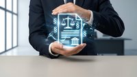 Businessman protecting digital legal justice scales icon with hands representing law firm services, legal protection and compliance consulting in modern office.