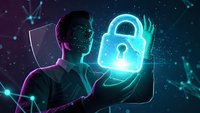 Young male cybersecurity expert holding glowing digital padlock hologram with shield icon in futuristic neon environment for data protection concepts.
