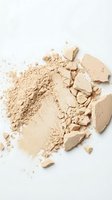 Crushed beige powder and compact makeup fragments on white background, suitable for cosmetics, beauty product advertising, skincare packaging design, and makeup tutorials.