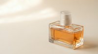 Elegant amber perfume bottle with golden fragrance on neutral beige background for luxury cosmetics and beauty product advertising campaigns.