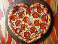 Heart-shaped pepperoni pizza with melted cheese and fresh basil on wooden board, romantic dinner concept for Valentine's Day celebration.