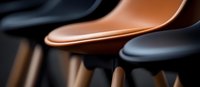 Modern bar stools in black and copper colors create minimalist contemporary interior composition with selective focus and blurred background effect.