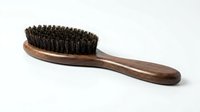 Wooden hairbrush with natural boar bristles on white background, suitable for hair care product photography and beauty grooming content.