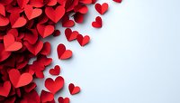 Red paper hearts scattered on white background creating romantic Valentine's Day love concept with copy space for text and design elements.