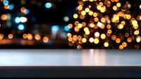 Blurred festive bokeh lights over empty white table surface, creating magical ambiance for product display or holiday celebration background.