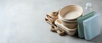 Eco-friendly bamboo fiber dinnerware set with plates, bowls and cups in natural beige tones, sustainable kitchen tableware for zero waste dining.