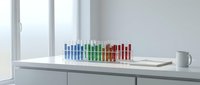 Laboratory test tubes with colorful chemical solutions arranged on white counter near window for scientific research and analysis experiments.