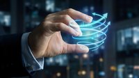 Businessman hand holding glowing blue energy sphere with swirling light trails in modern office environment for technology and innovation concepts.