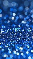 Blue glitter sparkle background with bokeh lights and shimmering particles for luxury celebration and festive holiday decorations.