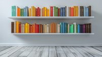 Colorful books arranged on floating white shelves against plain wall, wooden floor below. Modern minimalist home library interior design for reading and study space.