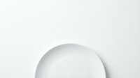 Minimalist white ceramic plate on neutral background, isolated design element suitable for tableware, dinnerware, and kitchen product mockups.