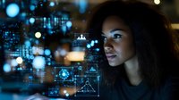 Young African American businesswoman analyzing digital data visualization with holographic interface elements and glowing blue technology graphics in modern office.