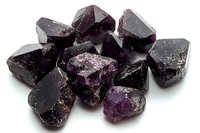 Raw purple amethyst crystal chunks with rough surfaces and natural geometric shapes on white background, isolated mineral specimens for collectors.