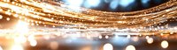 Abstract golden light trails with bokeh effect creating a festive, luxurious atmosphere for holiday backgrounds or celebration designs.