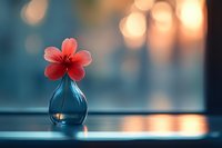 Single red flower in glass vase on windowsill with warm bokeh lights creating peaceful home decor atmosphere for interior design and relaxation concepts.