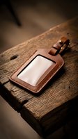 Handcrafted brown leather luggage tag with clear window on rustic wooden surface, showcasing artisan craftsmanship and vintage travel style.