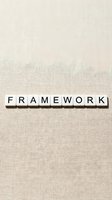 Wooden letter blocks spelling FRAMEWORK on neutral linen fabric background for business strategy and organizational structure concepts.