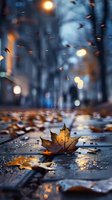 Fallen maple leaf on wet autumn street with bokeh lights and raindrops. Moody evening urban scene with golden leaves reflecting city illumination in puddles.