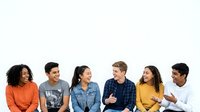 Diverse group of young adults in casual clothing standing together against white background, representing teamwork, friendship, and community engagement for lifestyle and social concepts.