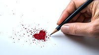 Hand holding black pencil drawing line to scattered red glitter heart shape on white paper, romantic creative concept for Valentine cards and love letters.
