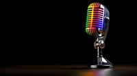 Vintage style microphone with rainbow colored metallic surface reflecting vibrant spectrum of light against dark background, dramatic studio lighting effect.