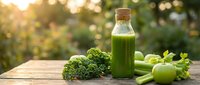 Fresh green vegetable juice in glass bottle with kale, celery and apple on wooden table. Healthy detox smoothie for wellness and nutrition lifestyle.
