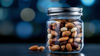 Glass jar filled with mixed nuts almonds hazelnuts walnuts healthy snacking storage container kitchen pantry organization food preservation.