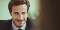 Confident businessman with charming smile in professional setting, looking sideways with subtle expression of success and charisma. Perfect for business presentations or corporate websites.