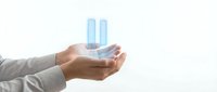Business professional hands holding holographic bar chart data visualization for financial analysis and corporate presentation on white background.