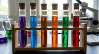Colorful chemical solutions in glass test tubes arranged in wooden rack for laboratory research and scientific experiments in modern lab setting.