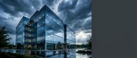 Modern glass office building with reflective facade and steel framework stands beside calm water under dramatic stormy sky with dark clouds, suitable for corporate, architecture, and business design projects.