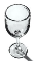 Empty wine glass with water droplets on white background isolated for restaurant menu design and beverage service presentations.