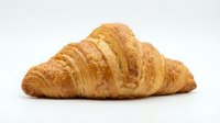 Fresh golden croissant with flaky layers isolated on white background for bakery menu design and food advertising projects.