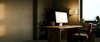 Modern home office workspace with computer monitor on wooden desk, ergonomic chair and warm ambient lighting creating productive work environment.